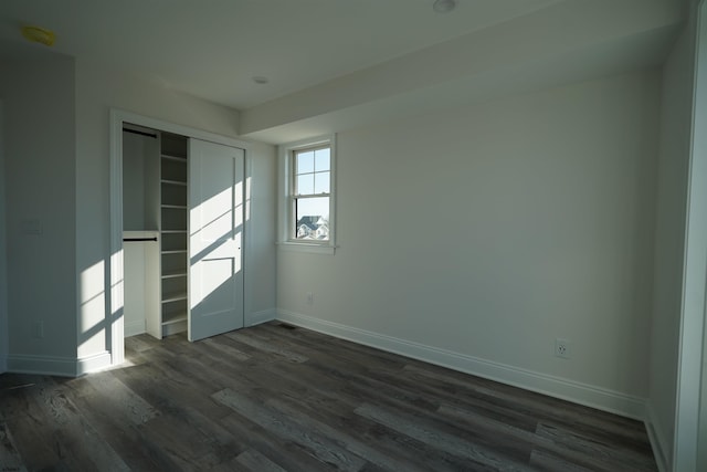 empty room featuring dark wood-type flooring