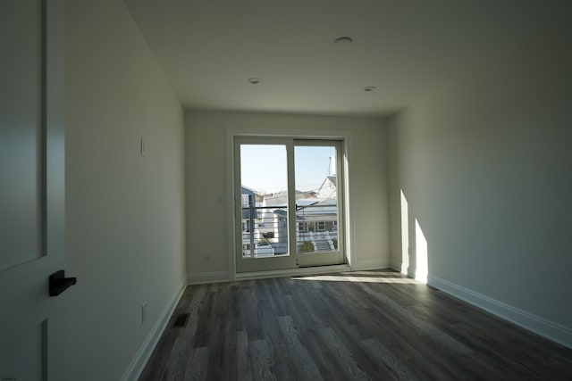 spare room featuring dark hardwood / wood-style flooring