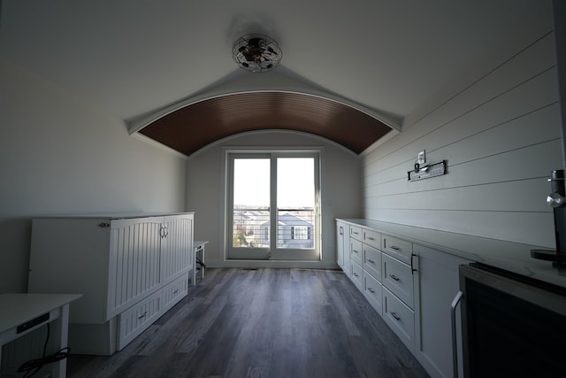 interior space with lofted ceiling and dark hardwood / wood-style flooring