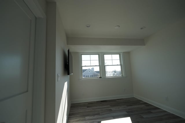 unfurnished room featuring dark hardwood / wood-style flooring