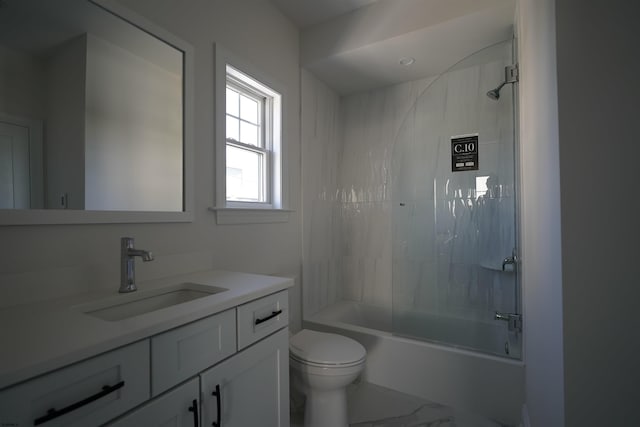 full bathroom with toilet, tiled shower / bath, and vanity