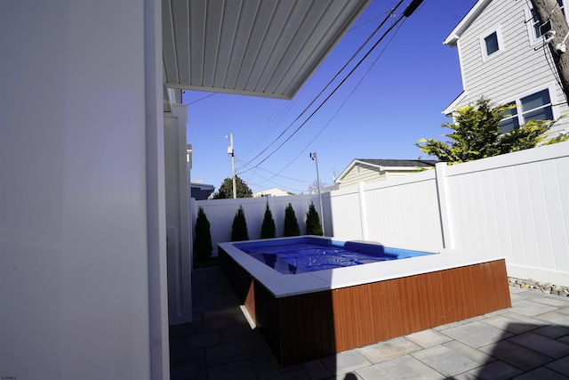 view of patio with a hot tub