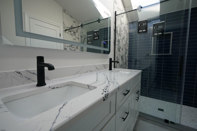 bathroom featuring tiled shower and vanity