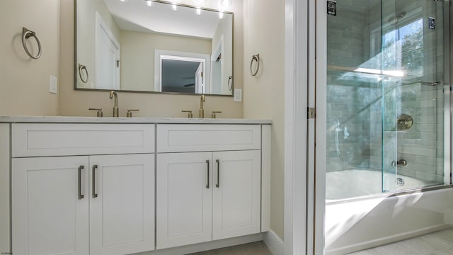 bathroom with vanity and bath / shower combo with glass door