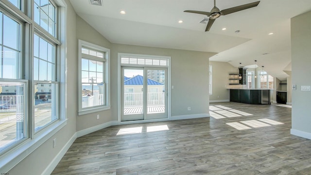 unfurnished living room with ceiling fan, light wood-type flooring, and lofted ceiling