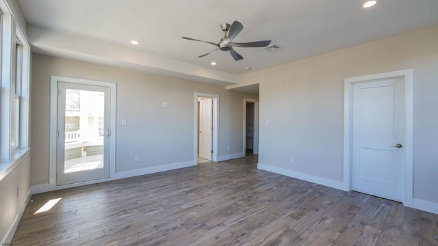 empty room featuring wood-type flooring and ceiling fan