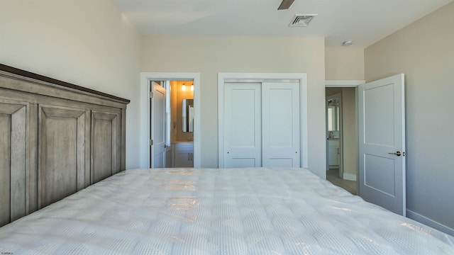 bedroom featuring connected bathroom, ceiling fan, and a closet