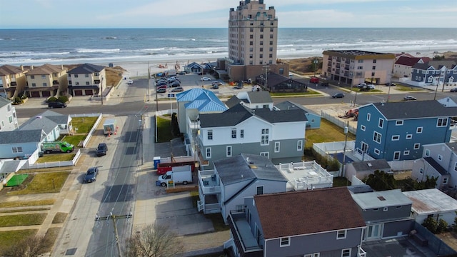 birds eye view of property featuring a beach view and a water view