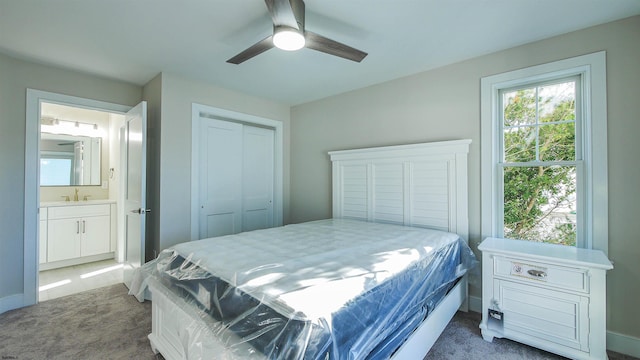 bedroom featuring dark colored carpet, a closet, ceiling fan, and sink