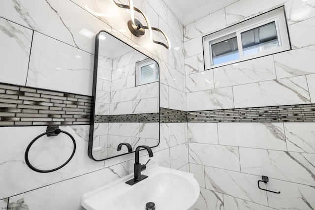 bathroom with tile walls, crown molding, and sink