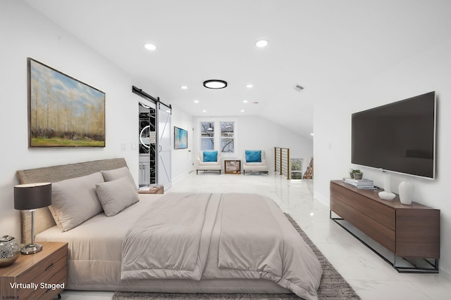 bedroom featuring a barn door and vaulted ceiling