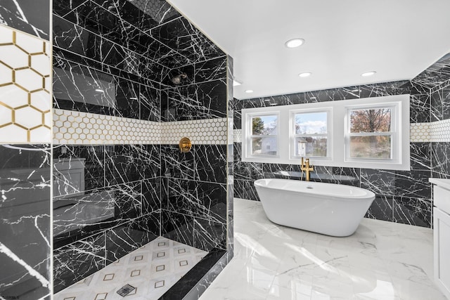 bathroom featuring a bathing tub and tile walls