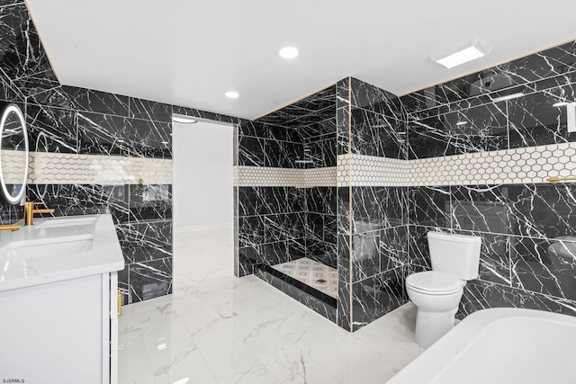 bathroom featuring walk in shower, vanity, tile walls, and toilet