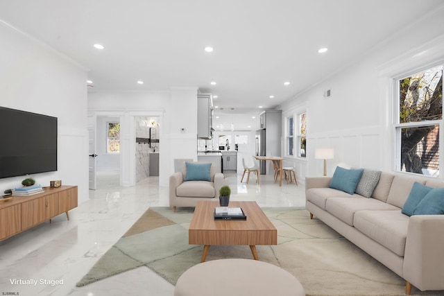 living room featuring plenty of natural light and ornamental molding