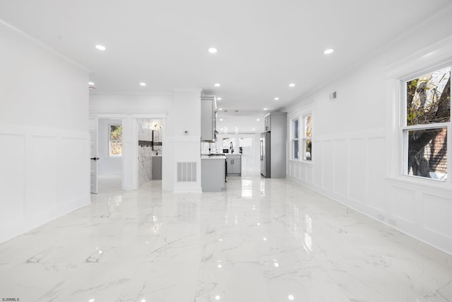 interior space featuring ornamental molding and a healthy amount of sunlight