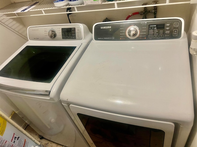 clothes washing area with separate washer and dryer