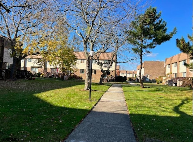 view of property's community with a lawn