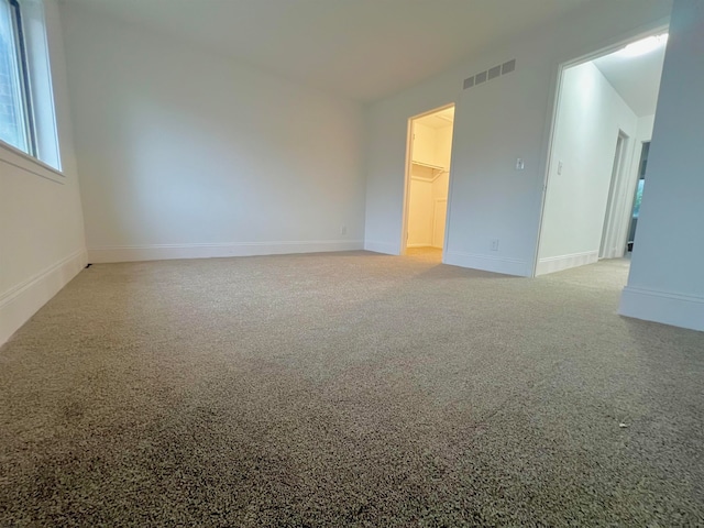 spare room featuring light carpet