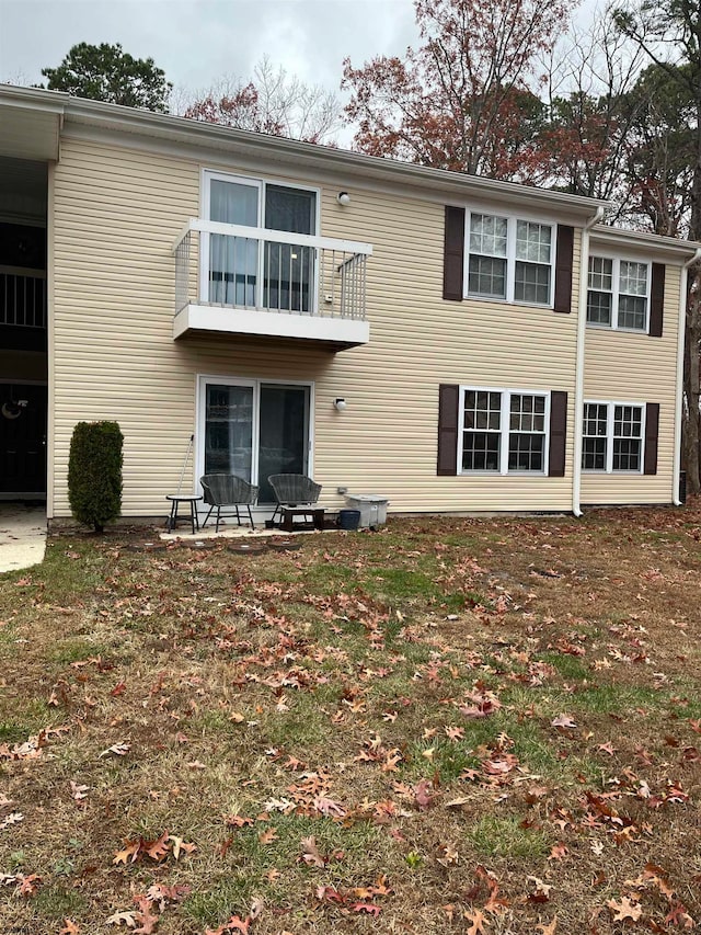 rear view of house featuring a balcony