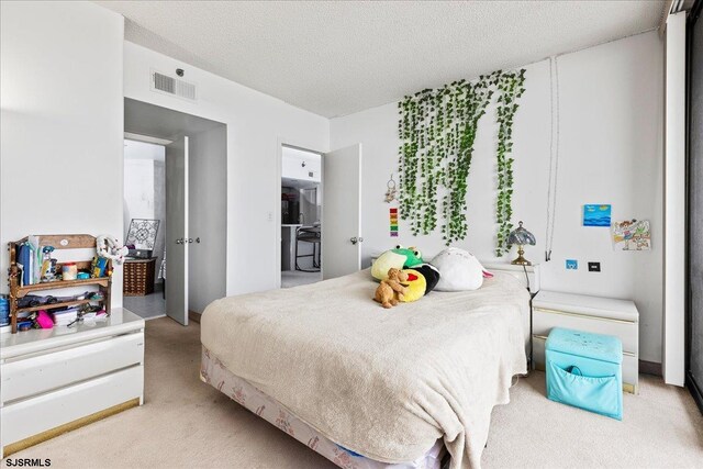 bedroom with carpet flooring and a textured ceiling