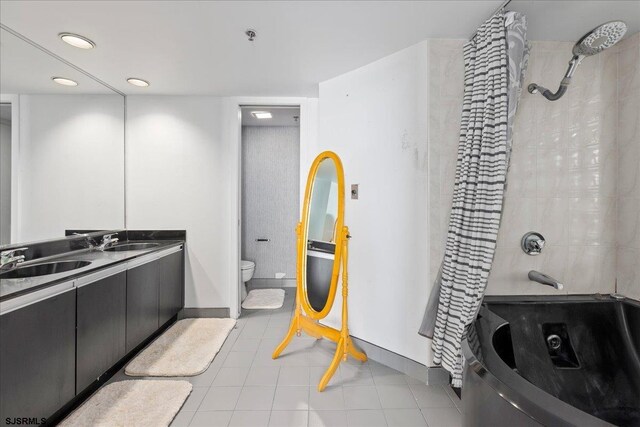 full bathroom featuring tile patterned floors, vanity, toilet, and tiled shower / bath