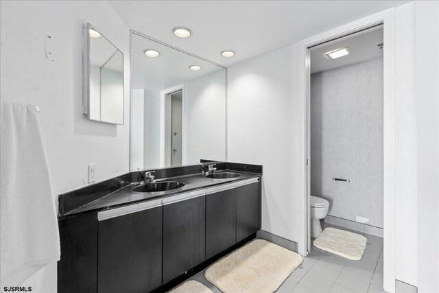 bathroom featuring tile patterned floors, vanity, and toilet