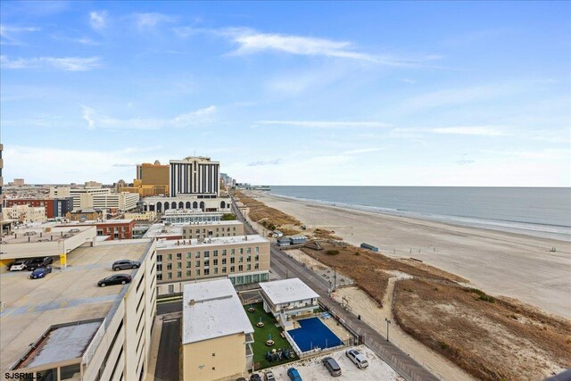 drone / aerial view with a water view and a beach view