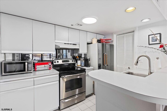 kitchen featuring white cabinets, sink, and appliances with stainless steel finishes