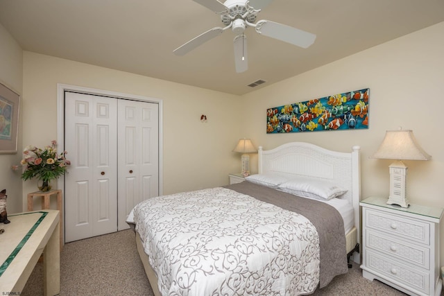 carpeted bedroom with ceiling fan and a closet