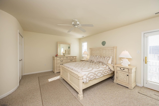 bedroom with ceiling fan, light carpet, and multiple windows