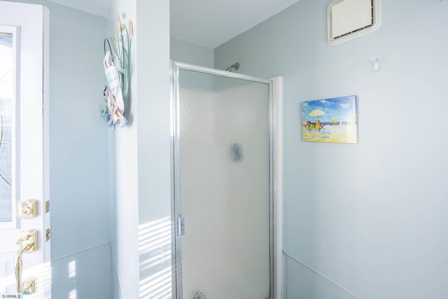 bathroom with a wealth of natural light and an enclosed shower