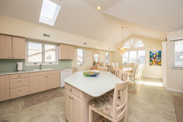 kitchen featuring dishwasher, pendant lighting, plenty of natural light, and sink