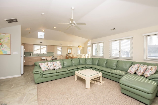 living room featuring ceiling fan, sink, and lofted ceiling