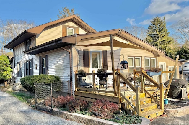 back of house with a wooden deck