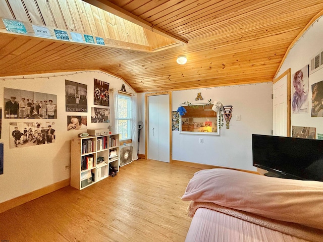 bedroom featuring hardwood / wood-style flooring, lofted ceiling with skylight, and wooden ceiling