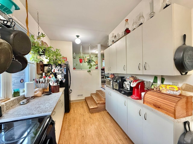 kitchen featuring white cabinets and light hardwood / wood-style floors