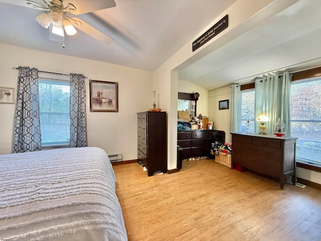 bedroom featuring ceiling fan, light wood-type flooring, baseboard heating, and vaulted ceiling