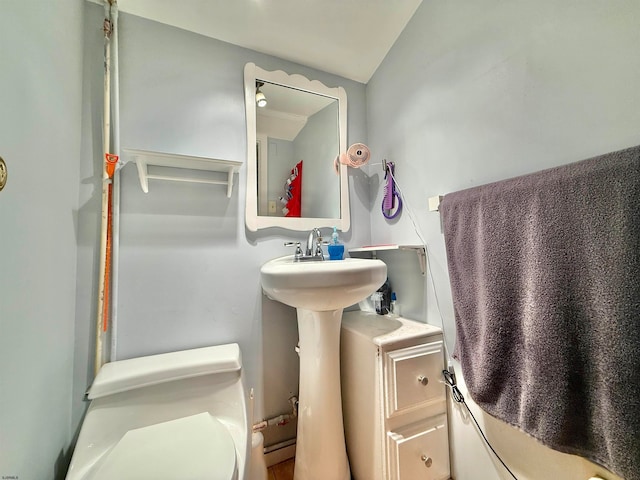 bathroom with toilet and lofted ceiling