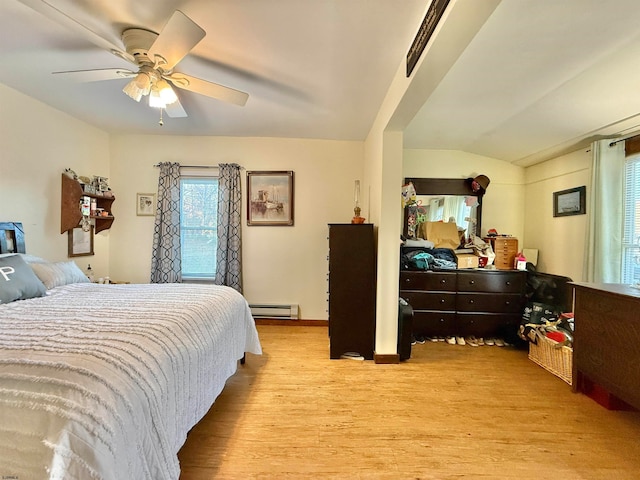 bedroom with lofted ceiling, light hardwood / wood-style floors, ceiling fan, and a baseboard heating unit