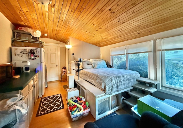 bedroom featuring wood ceiling, lofted ceiling, and light hardwood / wood-style floors