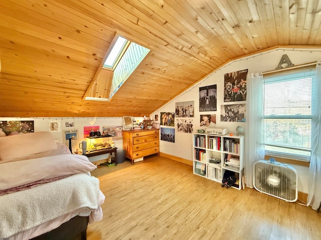 bedroom with light hardwood / wood-style flooring, lofted ceiling with skylight, and wooden ceiling