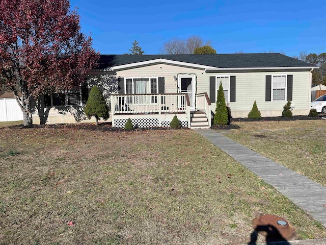 view of front of home featuring a wooden deck and a front lawn