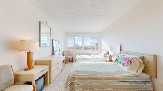 bedroom featuring a textured ceiling and light colored carpet