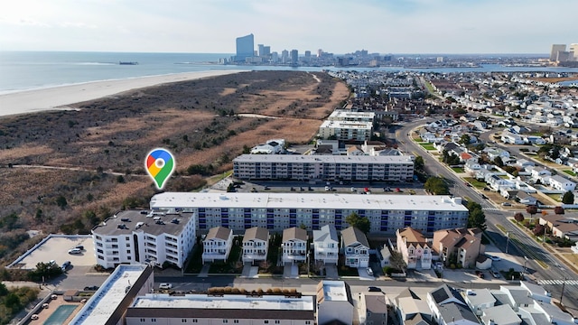 drone / aerial view featuring a view of the beach and a water view