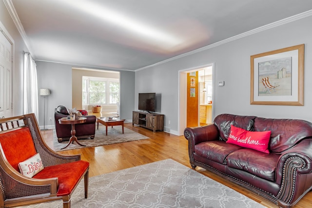 living room featuring hardwood / wood-style flooring and ornamental molding