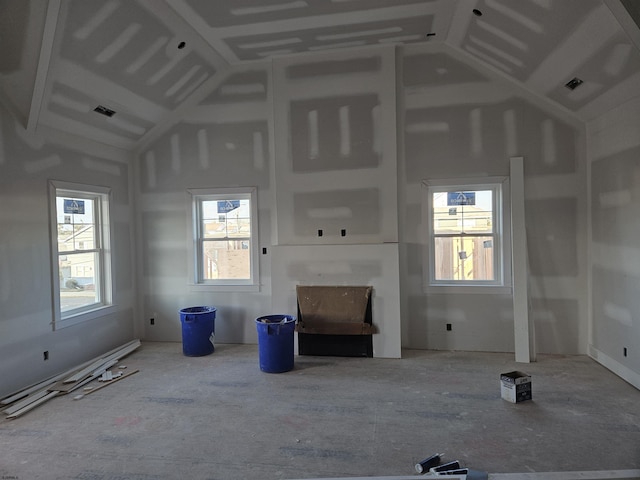 unfurnished living room featuring high vaulted ceiling