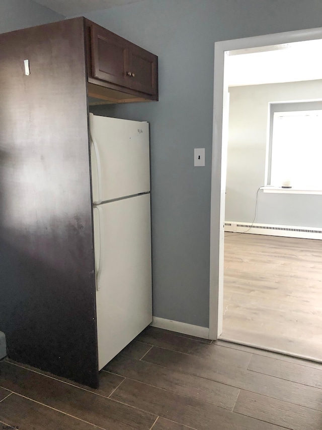 kitchen featuring white fridge and a baseboard heating unit