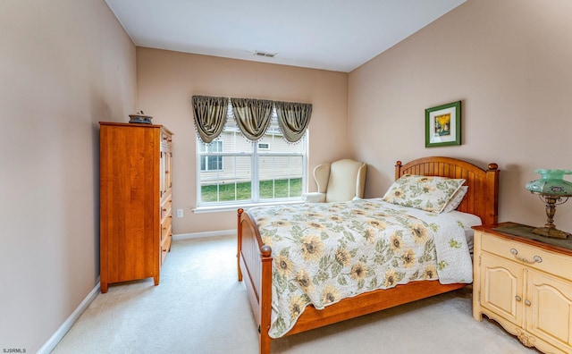 bedroom featuring light carpet