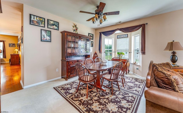 dining room with ceiling fan and light hardwood / wood-style floors