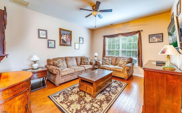 living room featuring ceiling fan and light hardwood / wood-style flooring